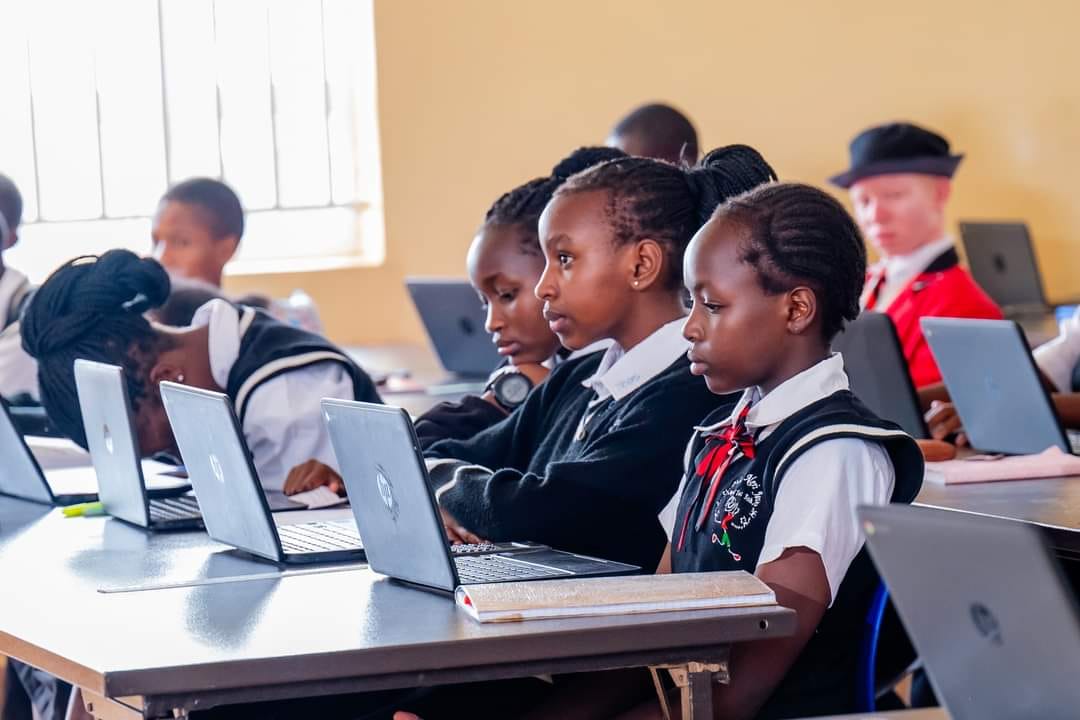 Happy students walking between modern facilities at the leading junior school in Joska, Kenya.